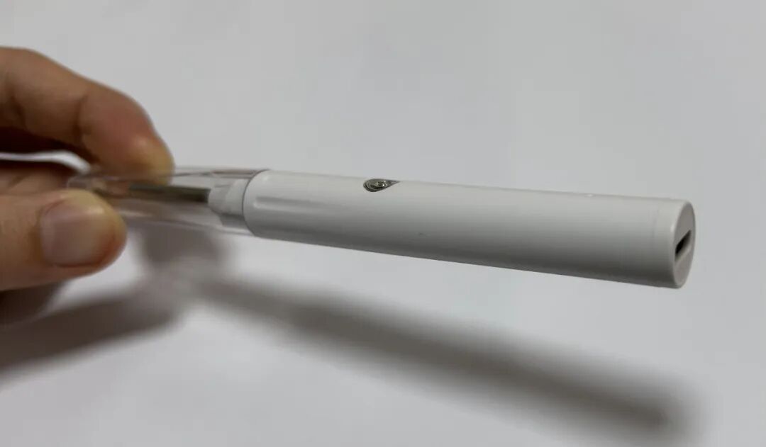一只手持的白色电子烟状设备