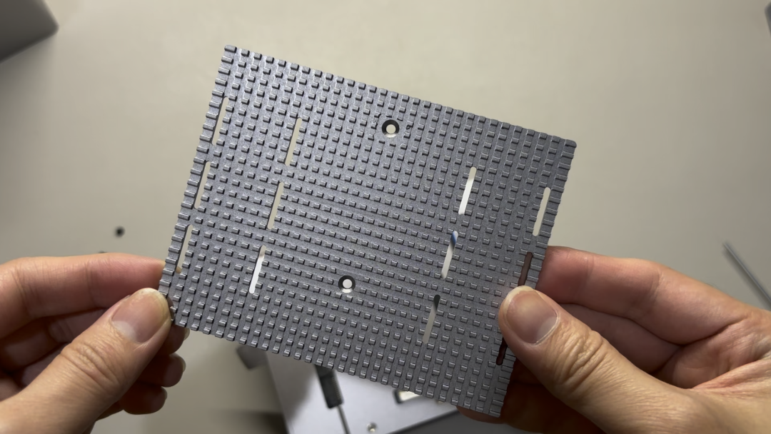手拿灰色乐高积木板