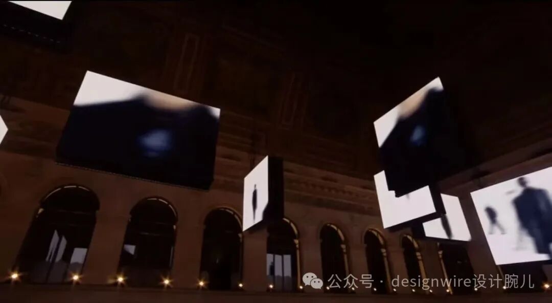 昏暗室内空间中，多个方形屏幕悬浮于空中，屏幕上显示模糊的黑白人形剪影及抽象光影；背景为古典建筑风格，有拱形门洞与立柱，地面排列暖色小灯；右下角有水印文字‘公众号 · designwire设计腕儿’。