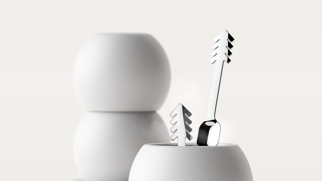 白色圆柱形容器与带有树形装饰的银色餐具