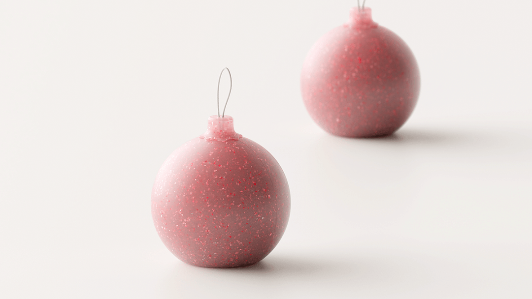 粉红色带闪光颗粒的球形圣诞装饰品