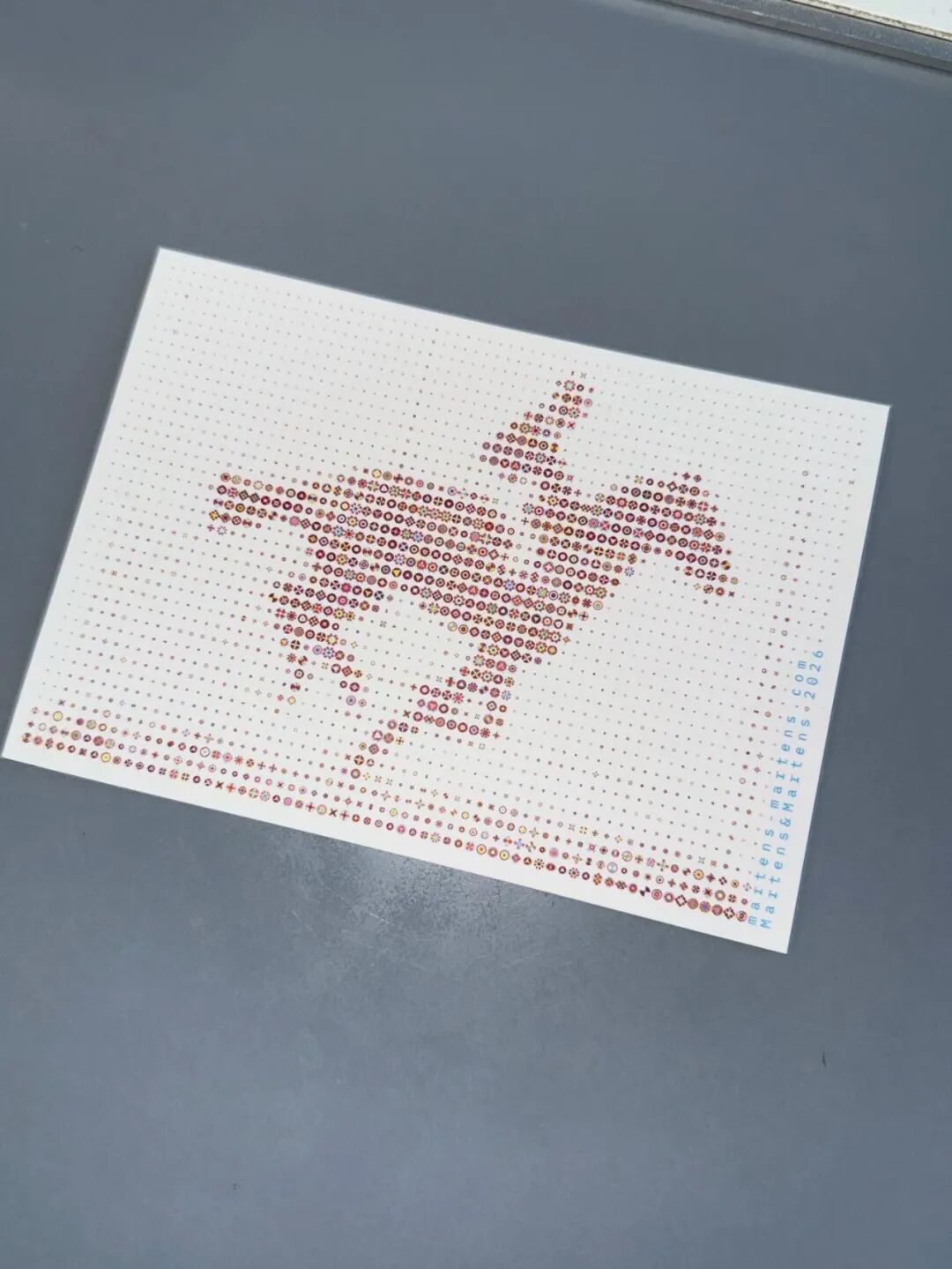 抽象艺术图：由彩色符号密集排列构成鸟形，右侧竖排蓝字“ENCYCLOPEDIA OF PRODUCTS”