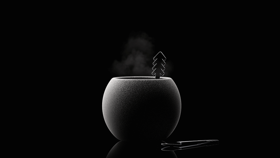 黑色圆形容器冒出蒸汽与圣诞树金属装饰