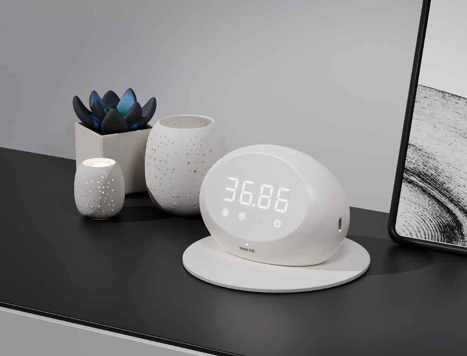 黑色桌面上的白色智能温控设备，搭配绿植与装饰画