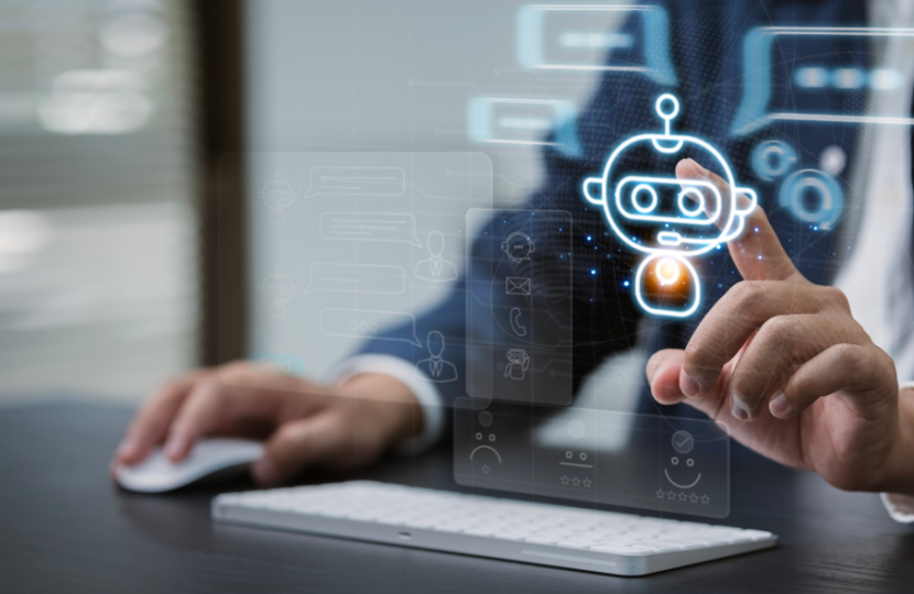 一名西装人员操作鼠标,与悬浮的蓝色AI客服机器人图标交互