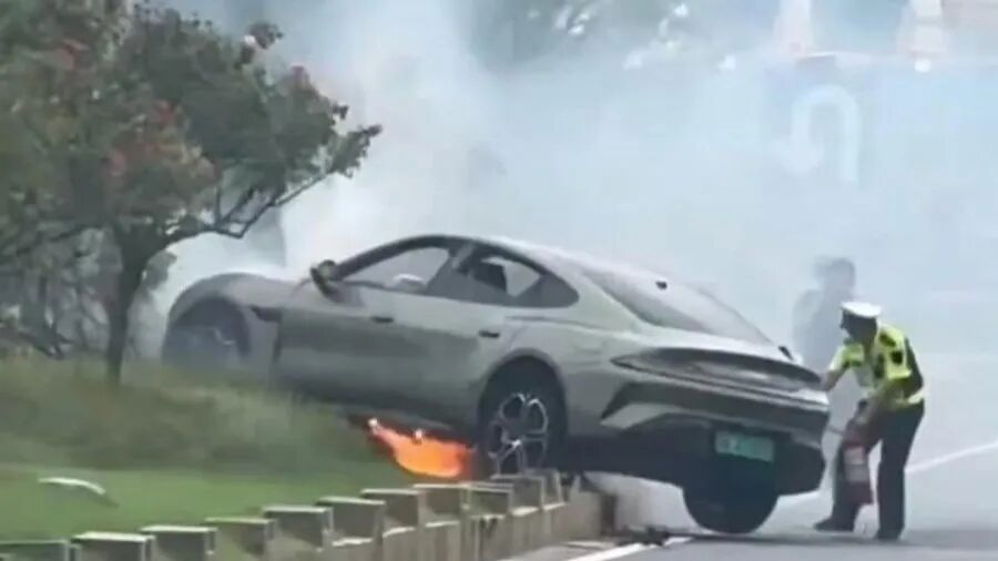 SU7侧翻起火，交警用灭火器进行处置现场图